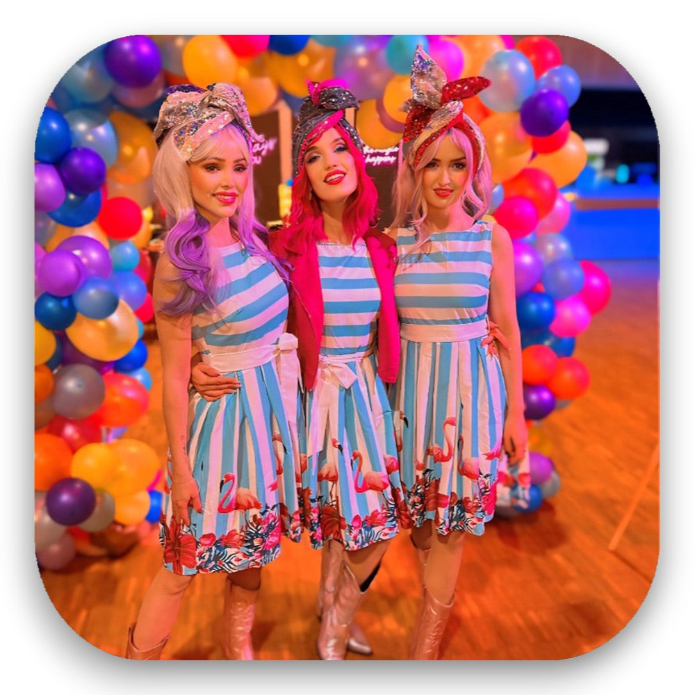 Lollipop Girls in gestreiften Kleidern mit Flamingo-Print & bunten Perücken – retro-süßer Candy-Charme vom GLITTERIMPERIUM von Elli Fatle. Jetzt farbenfrohe Show-Acts buchen!